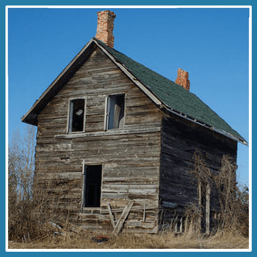 A rustic old barn that looks like it has a surprised face due to the window and door's location