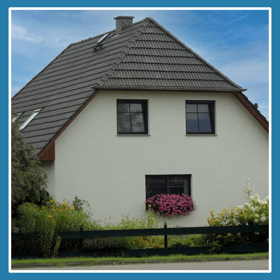 A cottage like house that look's like it is smiling with it's tongue out. The windows as eyes and a lower window as the mouth.